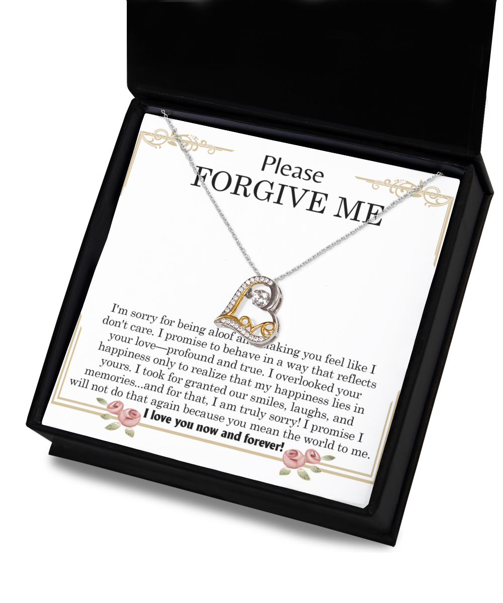 The "Sorry-Profound And True- Love Dancing Necklace," a heart-shaped pendant crafted in sterling silver, is displayed in a black box with a note that reads, "Please Forgive Me," featuring a heartfelt message of apology and love.