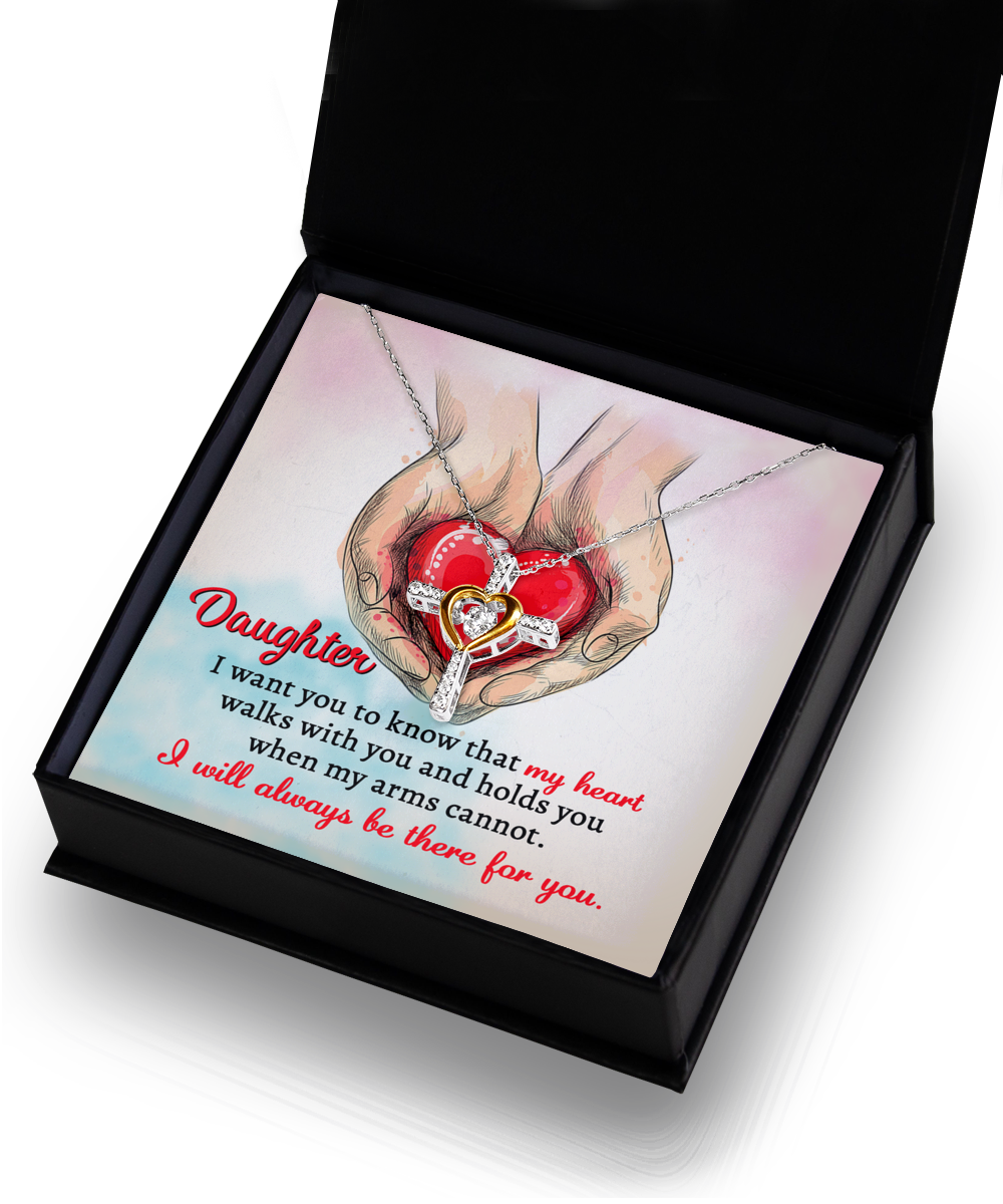 A Daughter-Always Be There - Cross Dancing Necklace inside a box with an illustration of hands holding a heart. Text reads: "Daughter, I want you to know that my heart walks with you and holds you when my arms cannot. I will always be there for you.