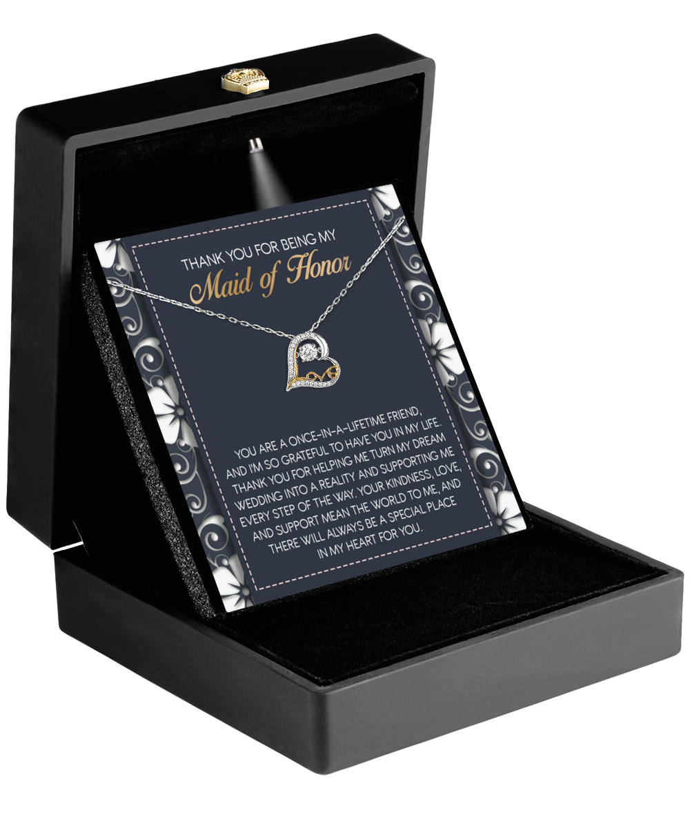 The "To Maid of Honor-World To Me - Love Dancing Necklace" nestled in a black box features a circular pendant. The accompanying card reads, "Thank you for being my Maid of Honor," expressing heartfelt gratitude with this perfect gift of appreciation.