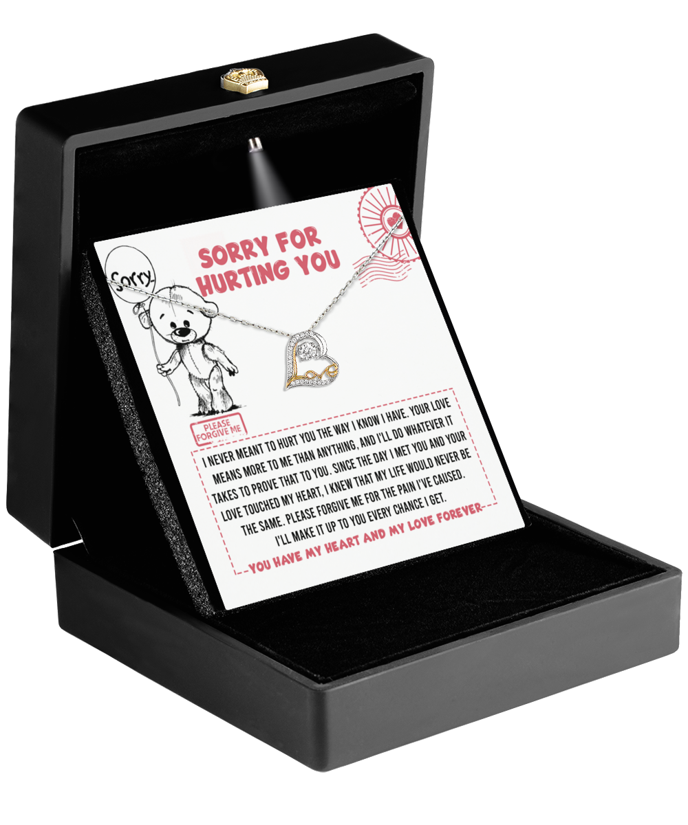 A black jewelry box containing a heartfelt note with an apology and a teddy bear design, along with the stunning Sorry-Every Chance - Love Dancing Necklace, which features a .925 Sterling Silver heart-shaped pendant.