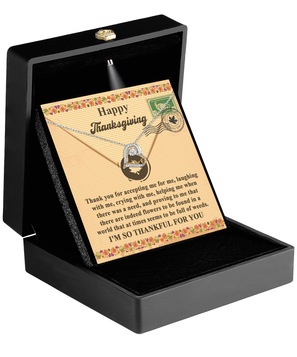 A black jewelry box presents the Thanksgiving-Proving To Me - Love Dancing Necklace featuring a shining sterling silver pendant, accompanied by a message card with "Happy Thanksgiving" and a floral border design, expressing gratitude.