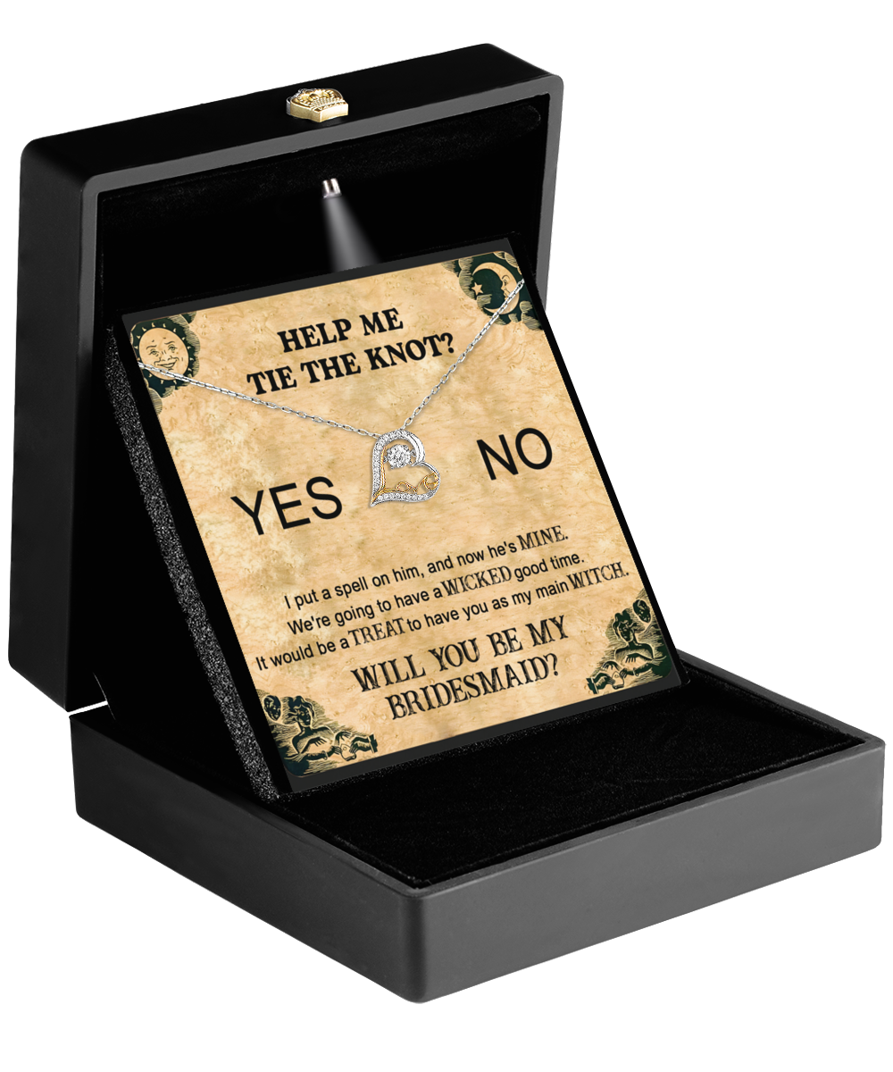 The Bridesmaid-My Main Witch - Love Dancing Necklace is beautifully packaged in a black box and comes with a card that reads "Help me tie the knot?" with options for "Yes" and "No." The text playfully asks, "Will you be my bridesmaid?" along with wedding-themed messages, making it an ideal personalized gift for your cherished friend.