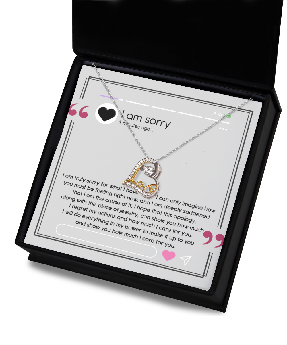 A sterling silver heart-shaped necklace, named the Sorry-Care For You - Love Dancing Necklace, is elegantly showcased in an open box with an apology message inscribed inside. The message conveys profound regret, love, and a promise to make things right.