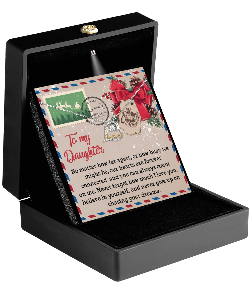 A decorative card nestled in a black box, featuring the Daughter-Forever Connected - Love Dancing Necklace, adorned with festive designs and addressed to a daughter, expressing love and encouragement.