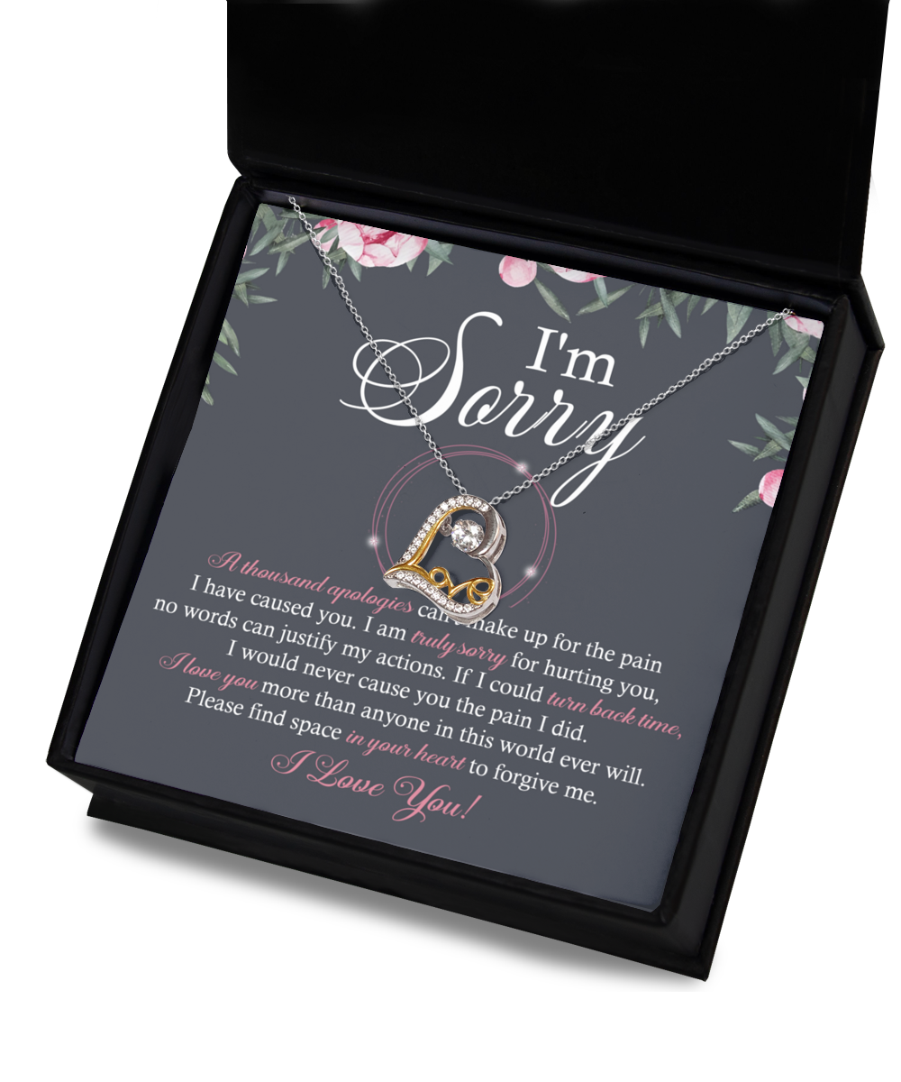 A Sorry-World Ever Will - Love Dancing Necklace, featuring a heart-shaped pendant crafted from 14k gold, rests on a card with a heartfelt apology message that reads: "I'm Sorry" and includes an extensive text expressing regret and seeking forgiveness.