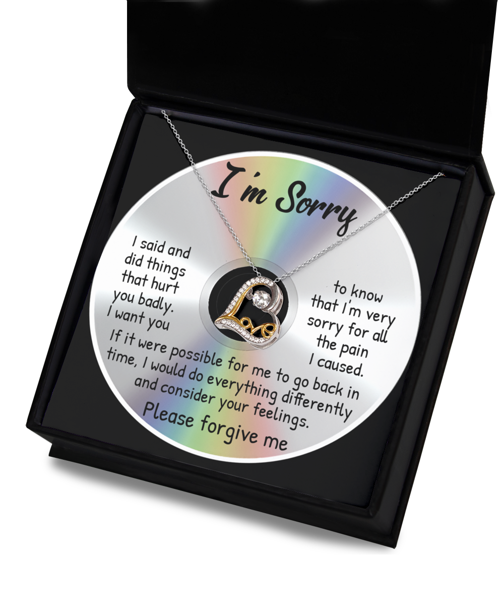 The "Sorry-Back In Time - Love Dancing Necklace" includes a CD with an apology message in a black box along with a 14k gold necklace featuring a "Love" pendant. The message expresses regret for causing hurt and seeks forgiveness.