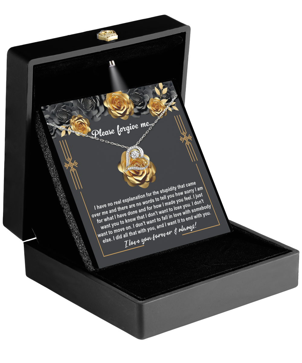 The Sorry-End With You - Love Dancing Necklace, crafted in 14k gold, features a heart-shaped pendant and is displayed in an open black box. Inside is a card that reads "Please forgive me," offering a heartfelt apology and expression of love, embodying elegance and emotion.