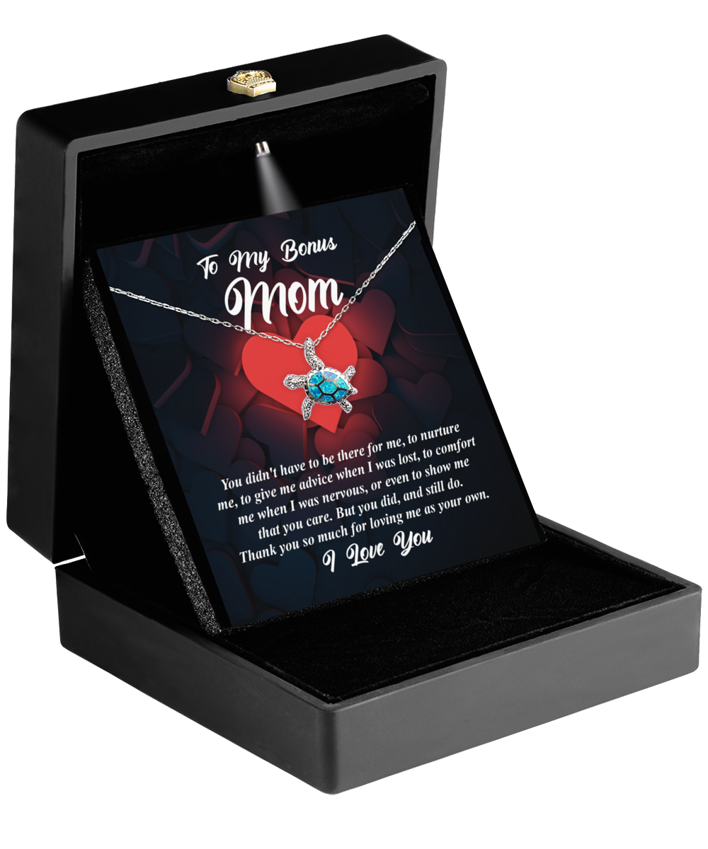 A necklace in a gift box with a heartfelt message dedicated to a stepmother. The "To Bonus Mom, That You Care" Opal Turtle Necklace from Gearbubble serves as a Symbol of Love, making it the perfect Bonus Mom Gift.