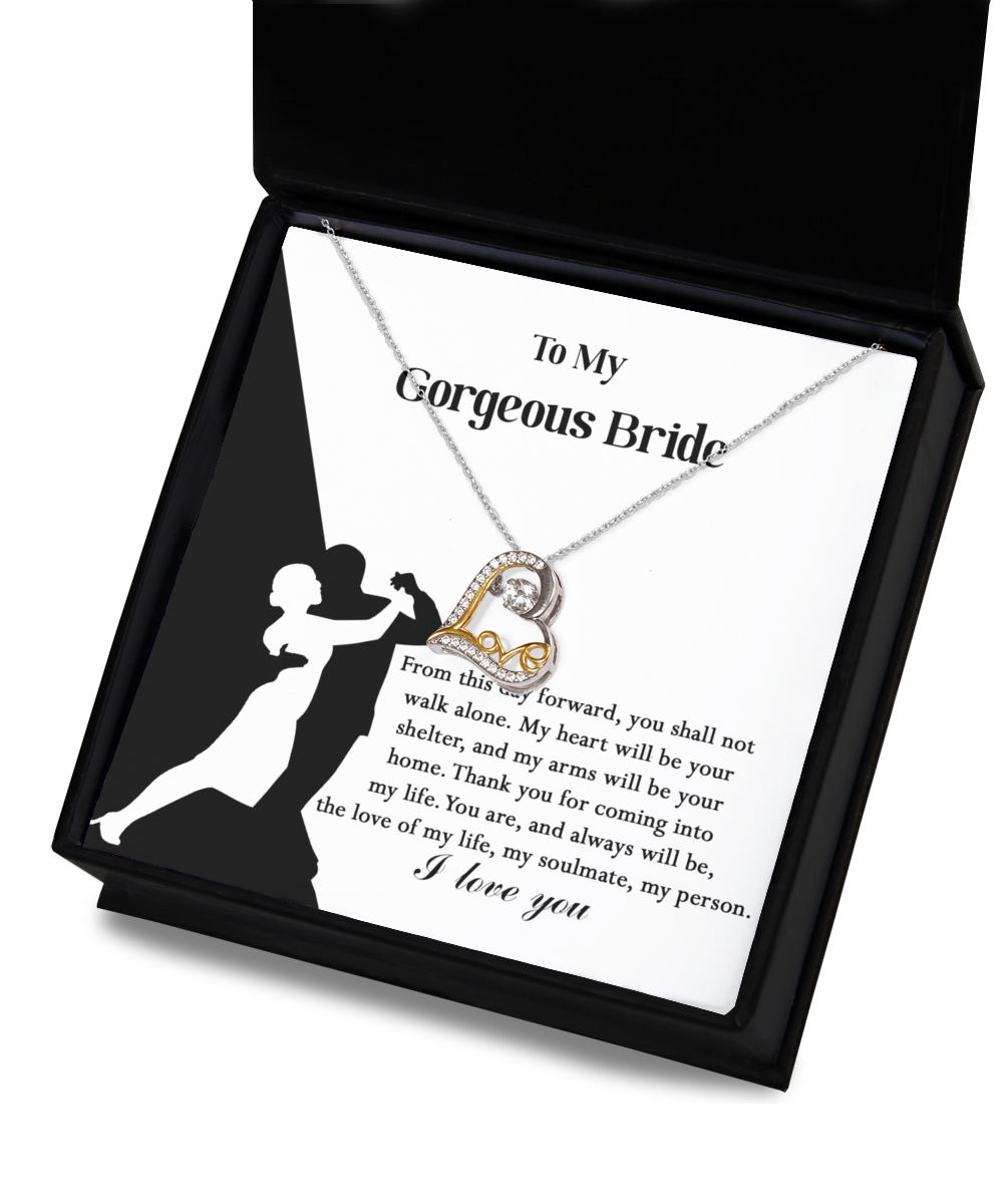 A Bride-Be Your Home - Love Dancing Necklace with a heart pendant, crafted in 14k gold plated, is displayed on a card featuring a silhouette of a dancing couple and a message addressing "My Gorgeous Bride," expressing love and commitment.