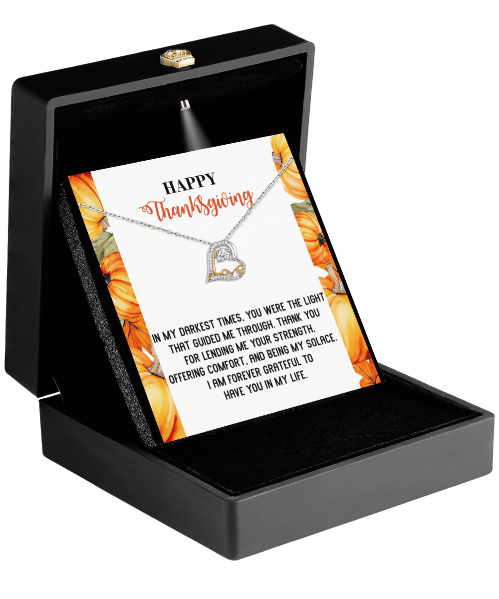 A sterling silver Thanksgiving-Guided Me Through - Love Dancing Necklace presented in a black box, accompanied by a card adorned with a graceful floral design and reading "Happy Thanksgiving," complete with a heartfelt message of gratitude.