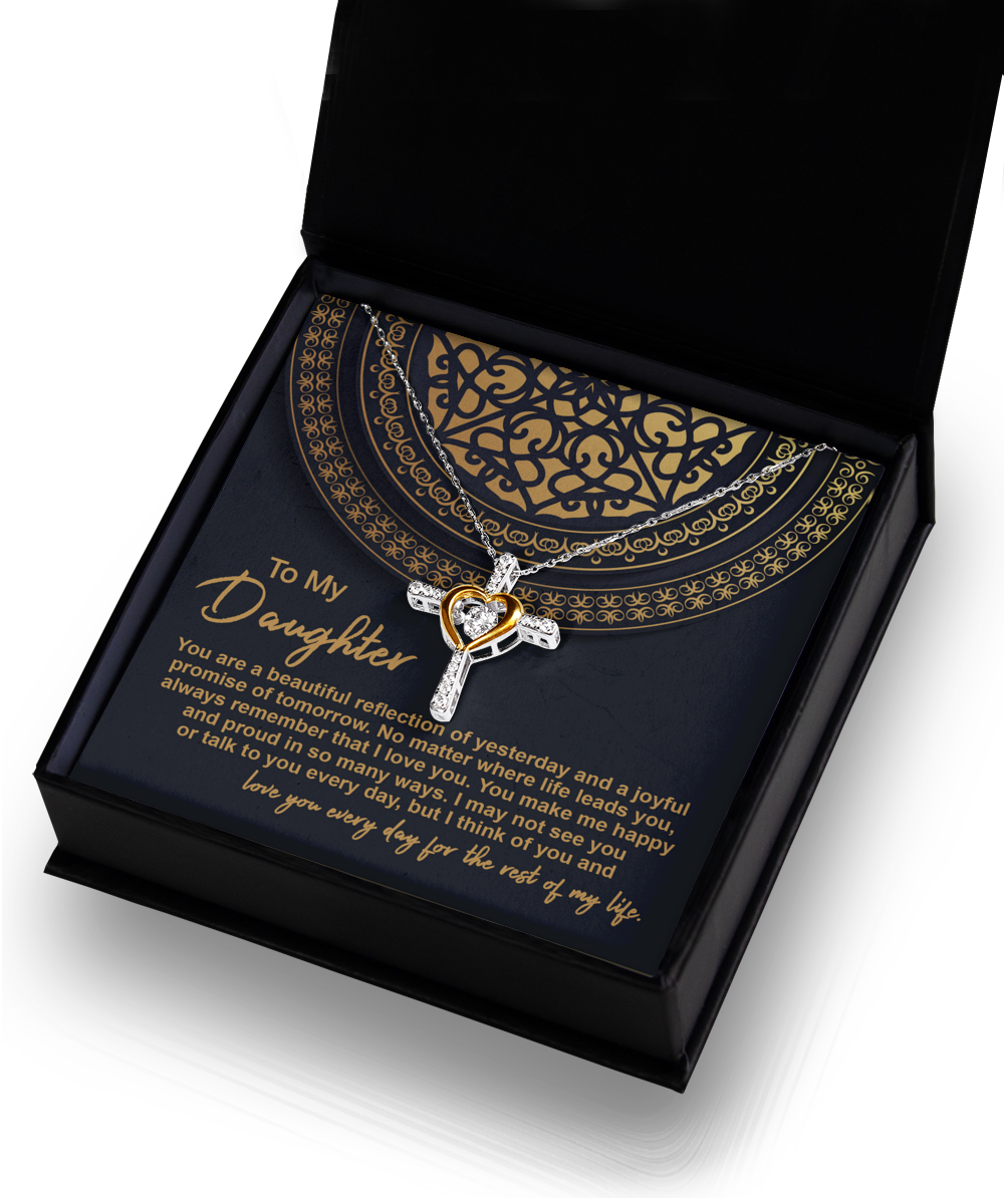 The "To Daughter-Beautiful Reflection - Cross Dancing Necklace" features a heart pendant in .925 Sterling Silver, elegantly presented in a black and gold gift box. Inside the box is a heartfelt message to a daughter, expressing pride, love, and happiness for her.