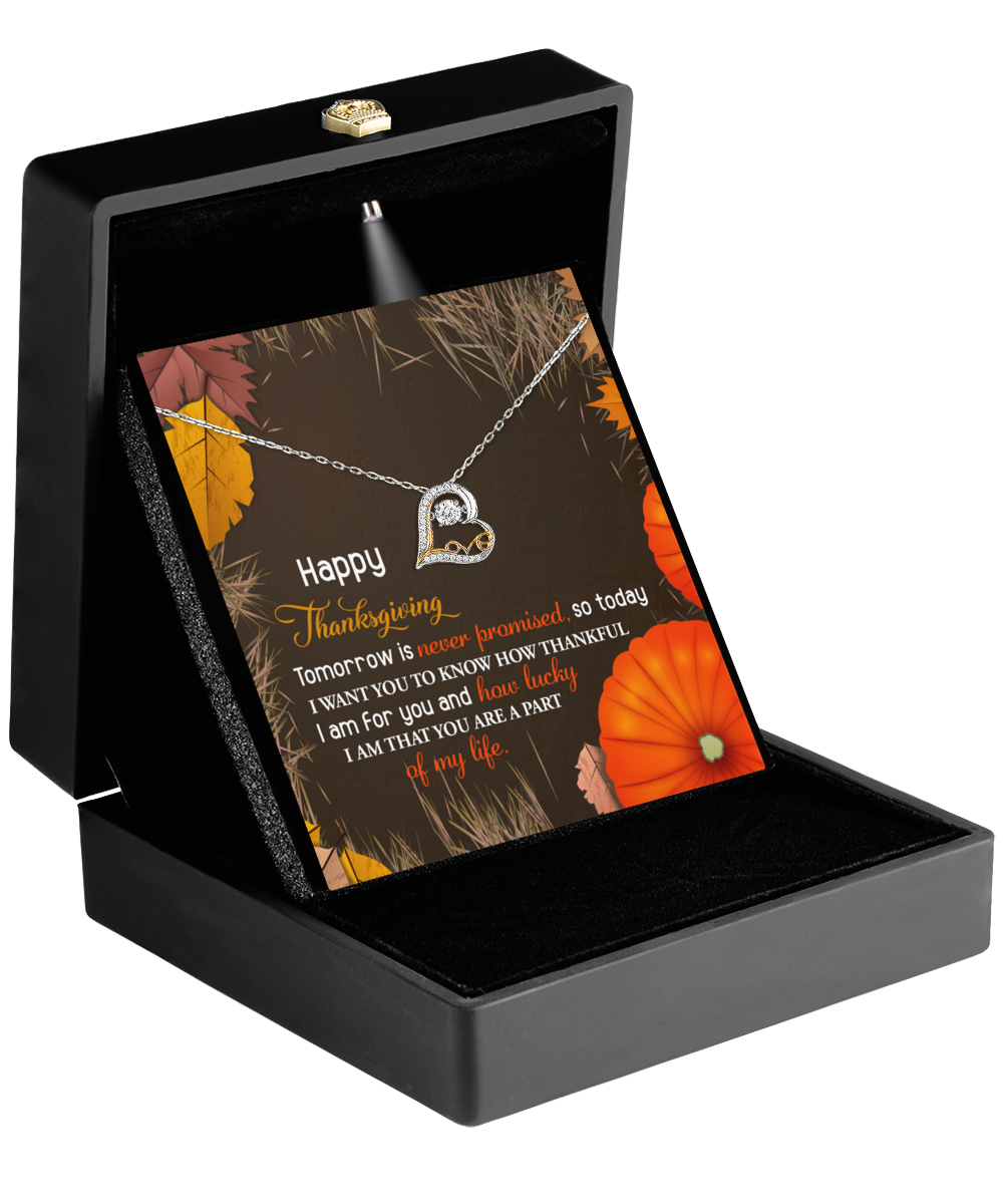 The Thanksgiving-How Lucky - Love Dancing Necklace, beautifully presented in a black box accompanied by a "Happy Thanksgiving" card, is elegantly displayed amidst pumpkins and leaves. Made from sterling silver, this exquisite piece perfectly embodies the season's charm.