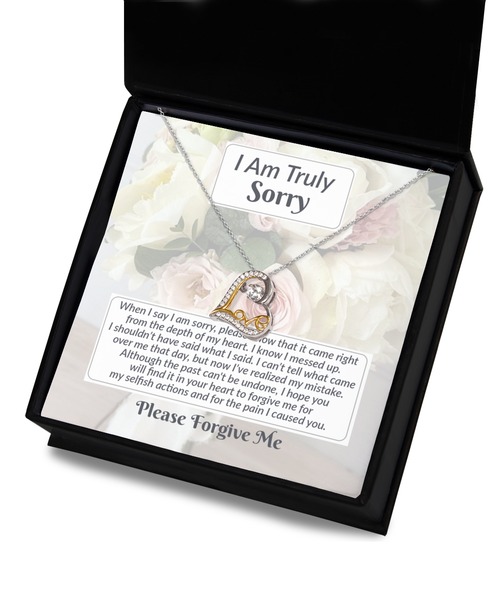 The Sorry-What I Said - Love Dancing Necklace is a rhodium-plated necklace featuring a heart-shaped pendant in a box, complemented by a heartfelt apology message expressing regret and requesting forgiveness. The message includes the phrases "I Am Truly Sorry" and "Please Forgive Me.