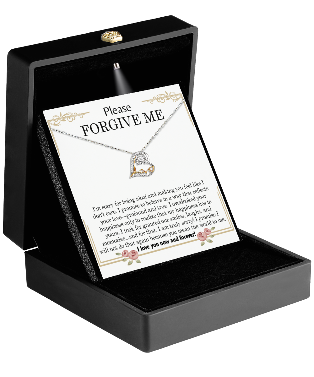 Open black jewelry box with a heartfelt "Please Forgive Me" message card, revealing the Sorry-Profound And True- Love Dancing Necklace inside, adorned with a stunning heart-shaped pendant crafted from 14k gold.