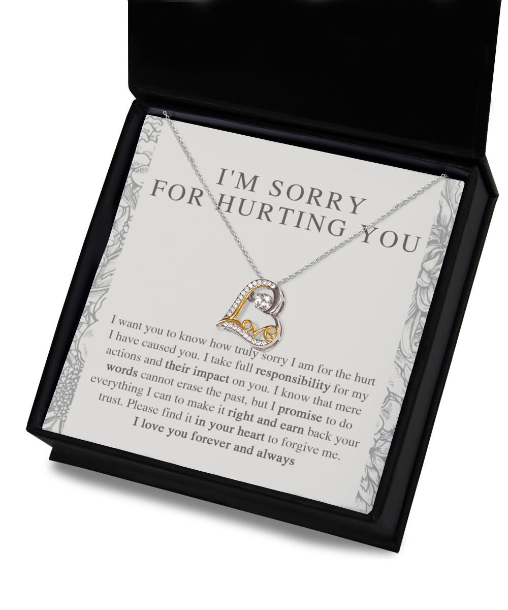 A sterling silver, heart-shaped pendant necklace called the "Sorry-Do Everything - Love Dancing Necklace" with intricate detailing is placed in an open black box. The box's lid displays an apology message, "I'M SORRY FOR HURTING YOU," along with a heartfelt note expressing regret, love, and a promise to make things right.