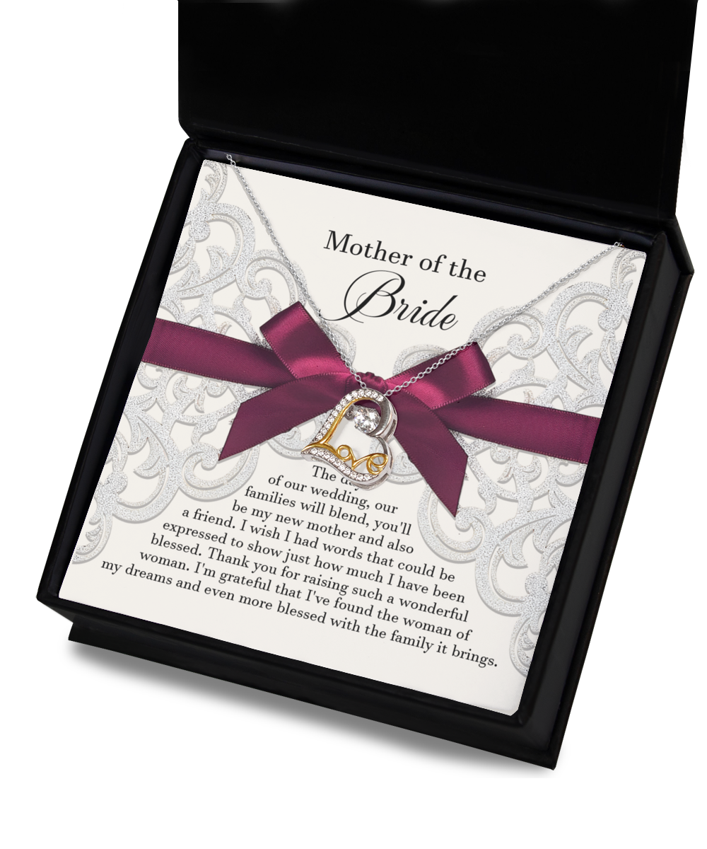 A "To Bride's Mom, My New Mother - Love Dancing Necklace" with a heart-shaped pendant on a silver chain. This handcrafted jewelry piece is beautifully displayed in a box, complete with a note expressing gratitude and love to the mother of the bride.