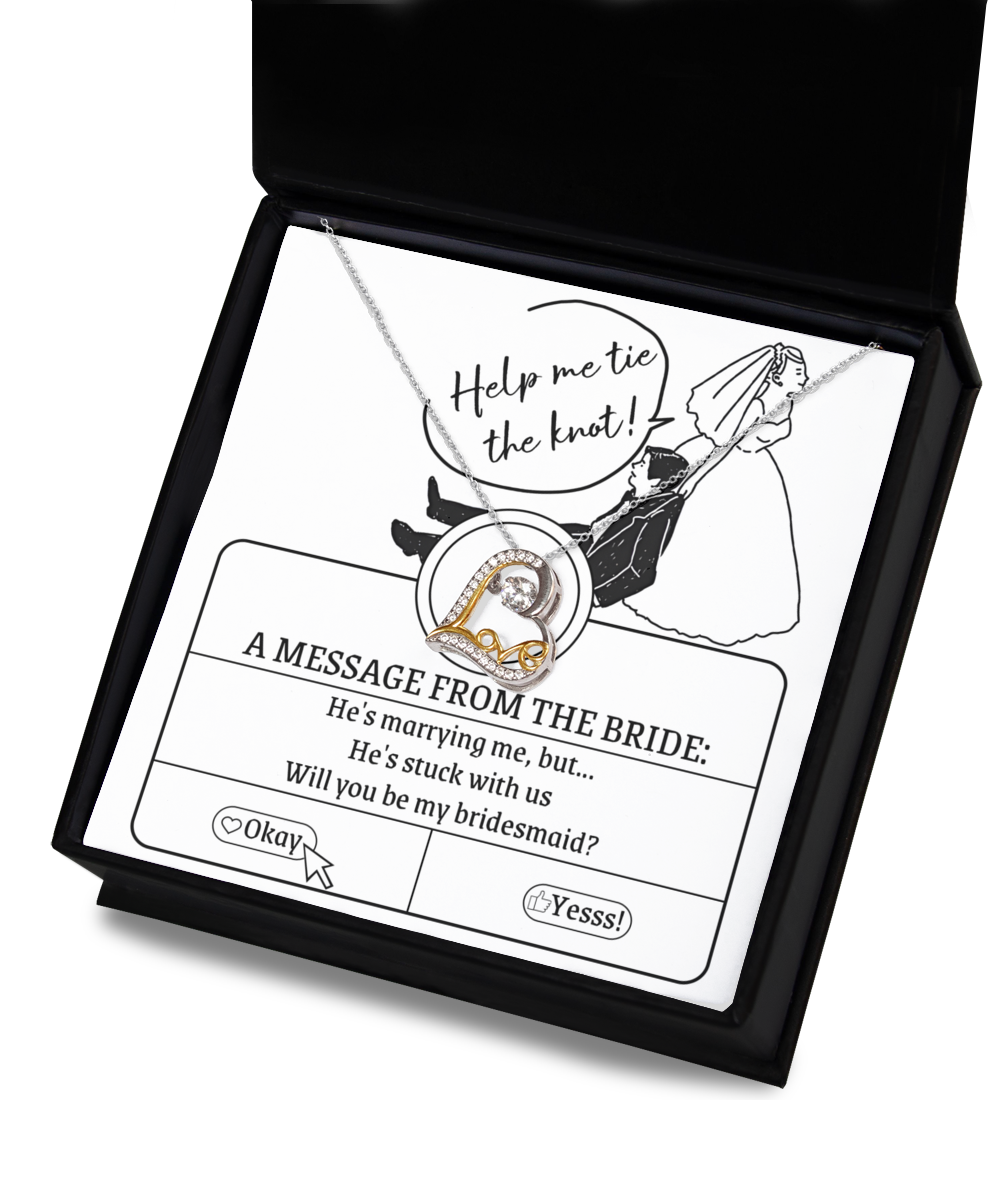 A Bridesmaid-Stuck With Us - Love Dancing Necklace with a 14k gold necklace inside. The box has an illustration of a bride pulling a groom with text: "He's marrying me, but... He's stuck with us. Will you be my bridesmaid?" and options "Okay" and "Yesss!".