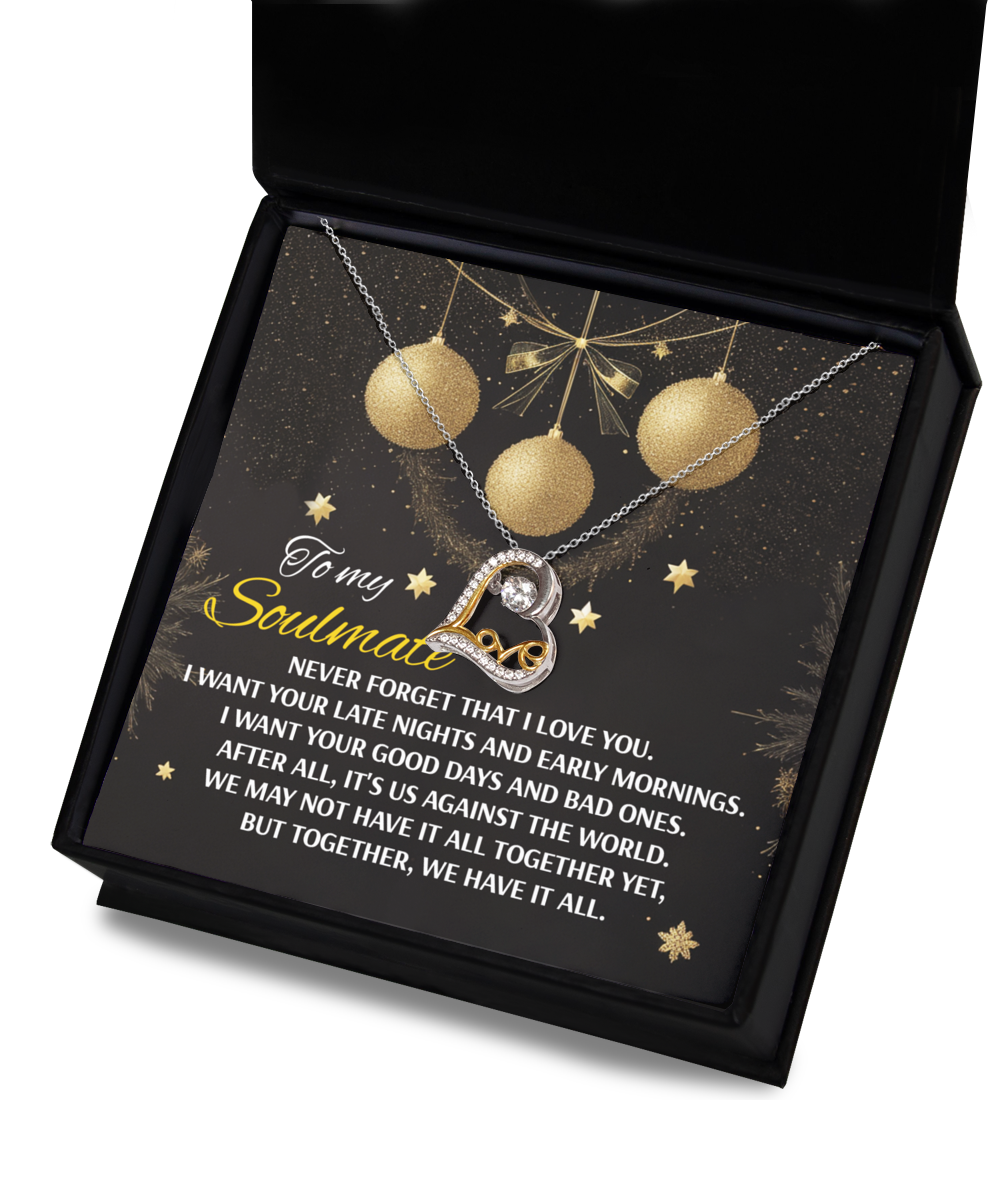 The Soulmate-Have It All- Love Dancing Necklace, featuring a circular pendant crafted in gleaming 14k gold, is elegantly presented in a box. The backdrop showcases a festive design adorned with the heartfelt phrase, "To my soulmate.