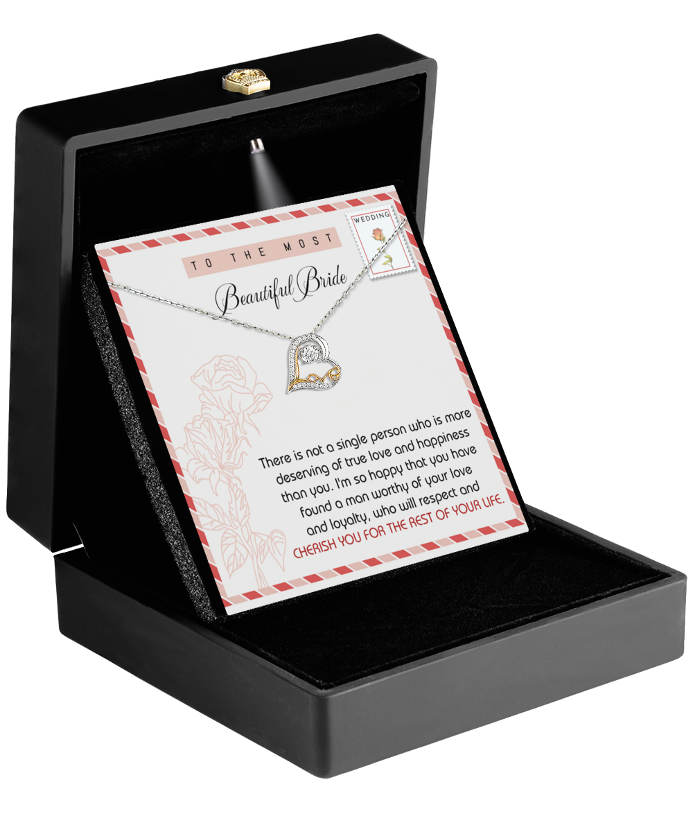 The Bride-Of Your Life - Love Dancing Necklace is elegantly presented in a black box and showcases a heart-shaped pendant adorned with a diamond. It comes with a touching card that reads, "To the most beautiful bride," conveying a heartfelt message about love and happiness, making it an ideal gift for the bride.