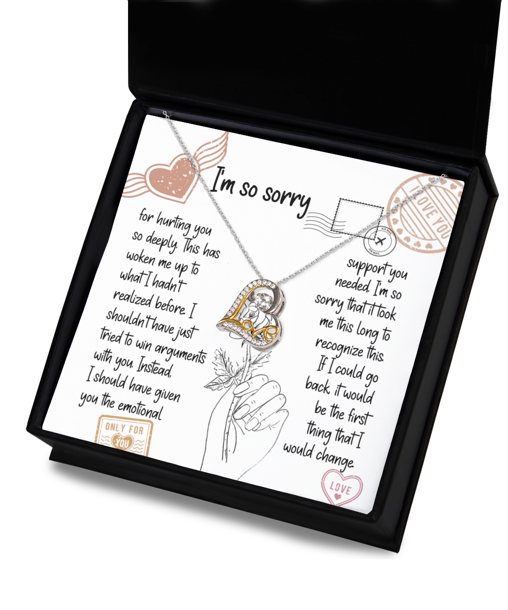 A "Sorry-Emotional Support- Love Dancing Necklace" with a heart pendant in .925 Sterling Silver is placed on an apology card inside a box. The card contains a heartfelt apology note with various decorative stamps and illustrations.