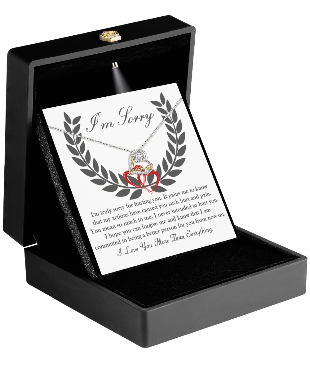 A black box containing the "Sorry-From Now On - Love Dancing Necklace," a sterling silver necklace with a heart-shaped pendant, along with a note that reads "I'm Sorry" featuring an apology and love message.