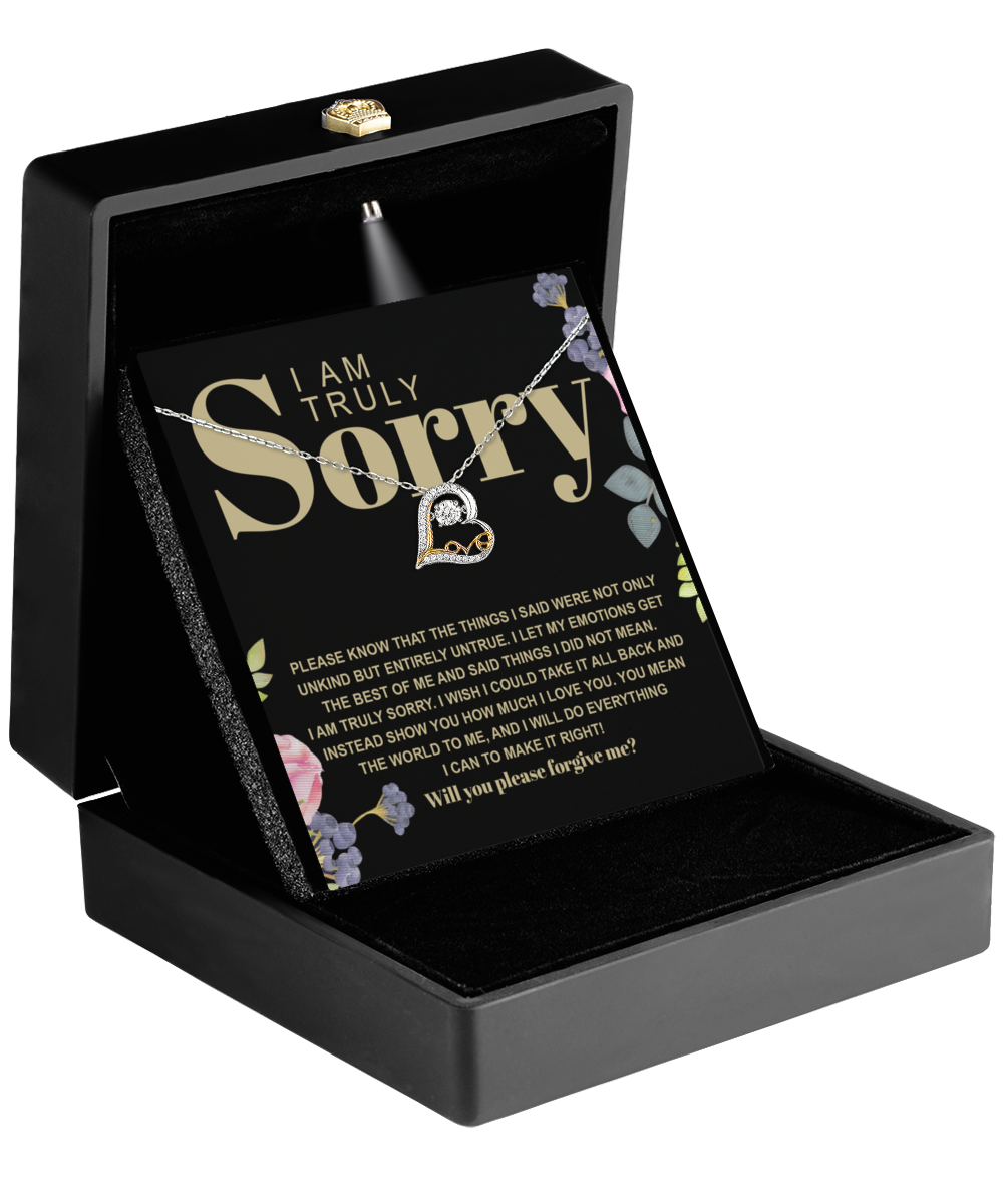 The Sorry-Best Of Me - Love Dancing Necklace with a 14k gold heart pendant is elegantly presented in a black jewelry box containing an apology card with floral accents.