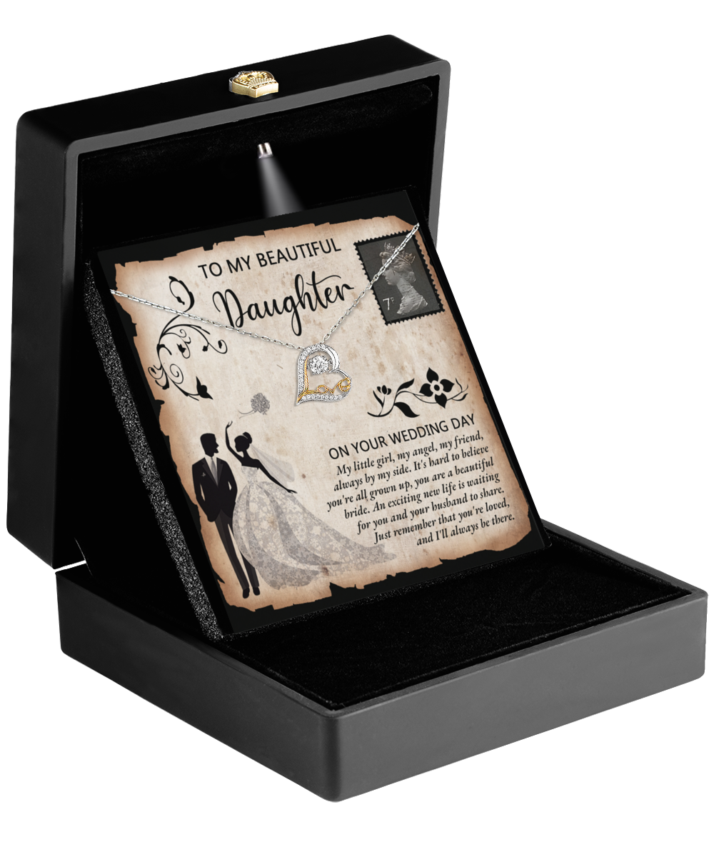 A black box featuring a wedding card adorned with a bride and groom illustration, complemented by a heartfelt message to a daughter and the Love Dancing Necklace. The Daughter Wedding - Beautiful Bride gift elegantly symbolizes the special bond shared on her unforgettable day.