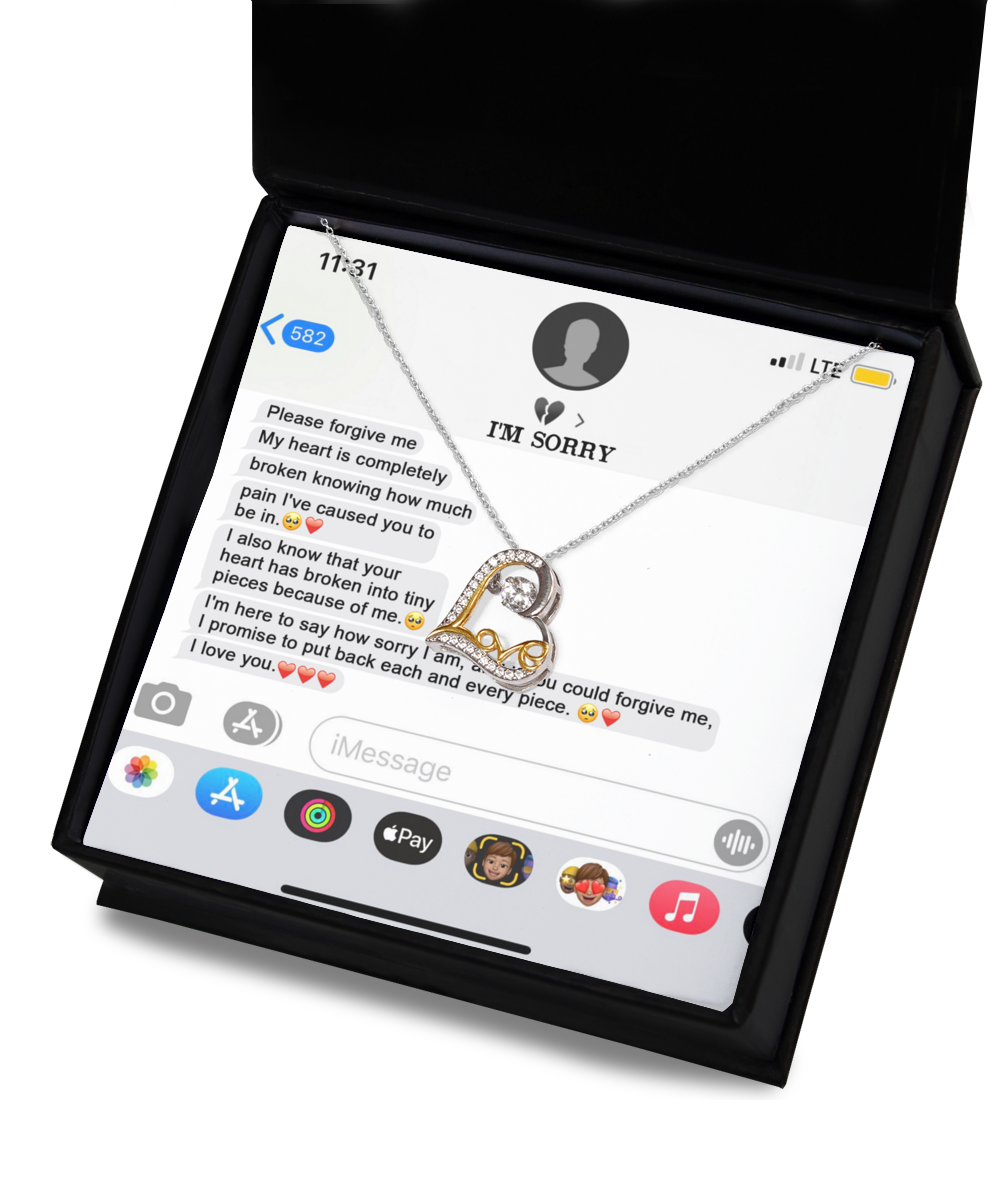 A heart-shaped pendant necklace displayed in an open box. The lid shows a text message conversation expressing apologies and love, with emojis interspersed in the messages. This sterling silver Sorry-Completely Broken - Love Dancing Necklace, plated with 14k gold, adds a touch of elegance to heartfelt moments.