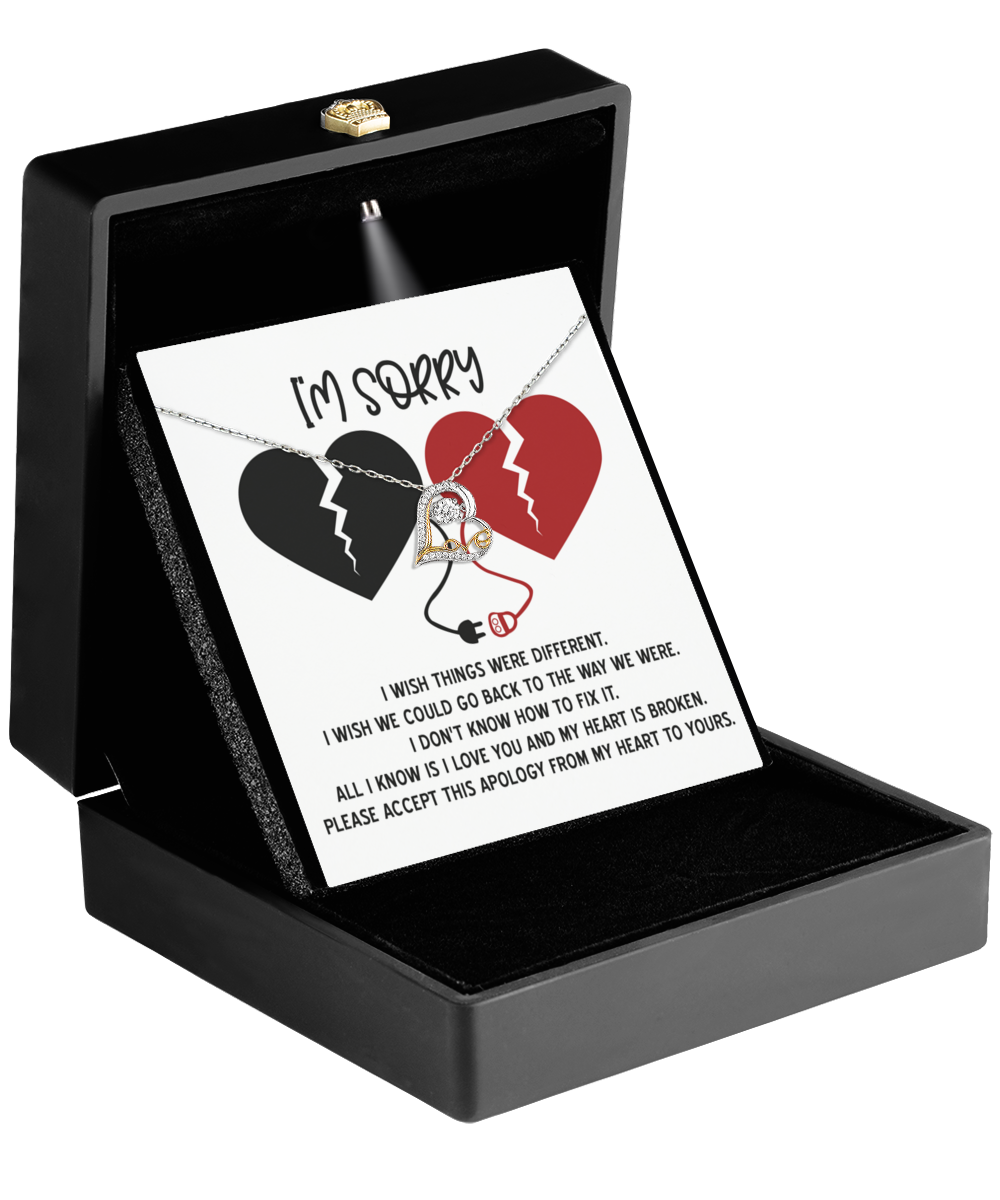 Open the jewelry box to reveal a Sorry-Heart Is Broken - Love Dancing Necklace crafted from 14k gold. A card with two broken hearts and an apology reading "I'm Sorry" accompanies it, offering amends in the most heartfelt way.