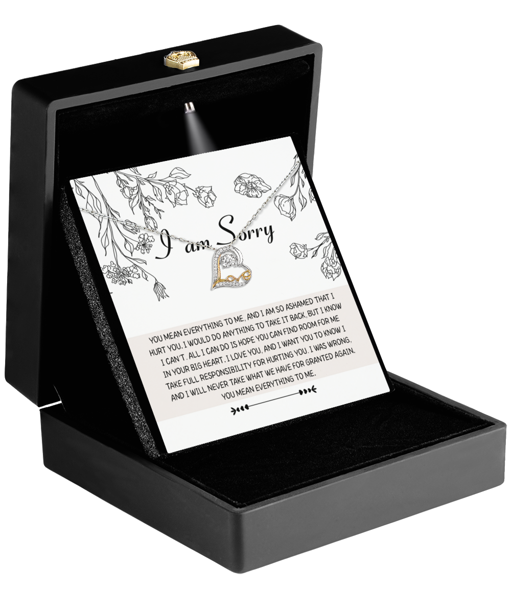 A "Sorry-Your Big Heart" Love Dancing Necklace, featuring an apology card within a black gift box adorned with a floral border and paired with a heart-shaped pendant, expressing maternal love.