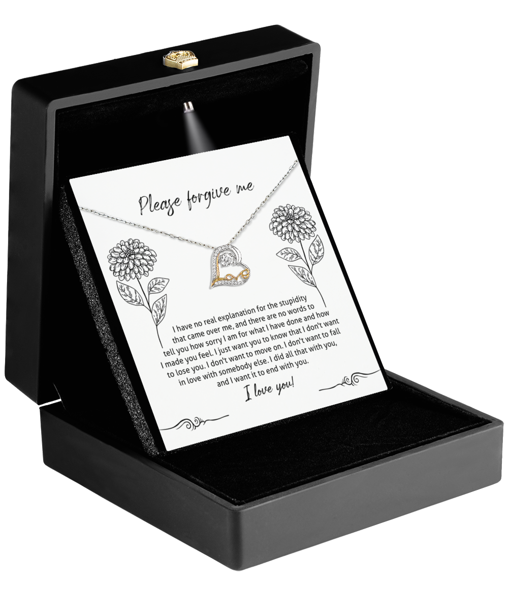 The Sorry-Real Explanation - Love Dancing Necklace features a 14k gold heart-shaped pendant with interlocking hearts. It is elegantly presented in an open black box and includes an apology note with floral designs, making it ideal for gestures of love and reconciliation.