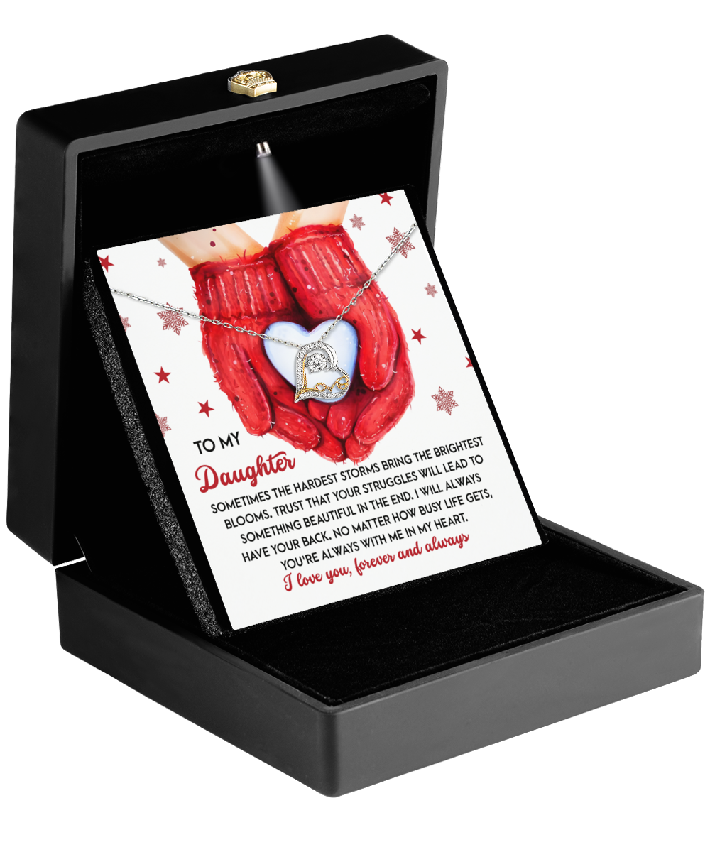 The "Daughter-In My Heart - Love Dancing Necklace" comes in a black box with a card for "My Daughter." Featuring hands holding a heart, it delivers a heartfelt message that perfectly captures maternal love.