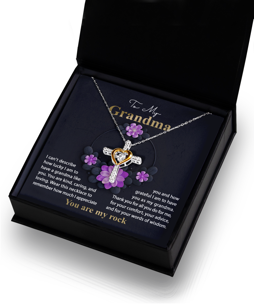 A To Grandma, Words Of Wisdom - Cross Dancing Necklace with a heart-shaped pendant, presented in a Gearbubble 14k Gold Plated gift box with a sentimental message for a grandmother.