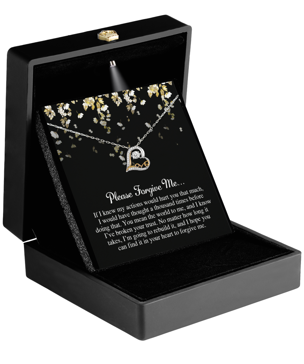 The Sorry-Broken Your Trust - Love Dancing Necklace, adorned with AAAA Cubic Zirconia, is displayed in an open black jeweler's box alongside a decorative card that says "Please Forgive Me.