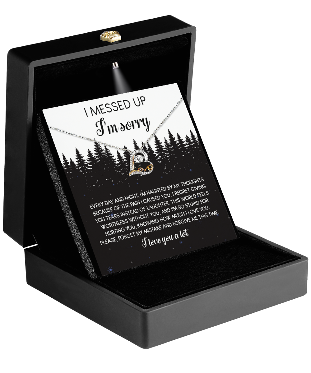 A black jewelry box contains the 14k gold "Sorry-By My Thoughts - Love Dancing Necklace" with a heart-shaped pendant, including a message of love and sincere apology.