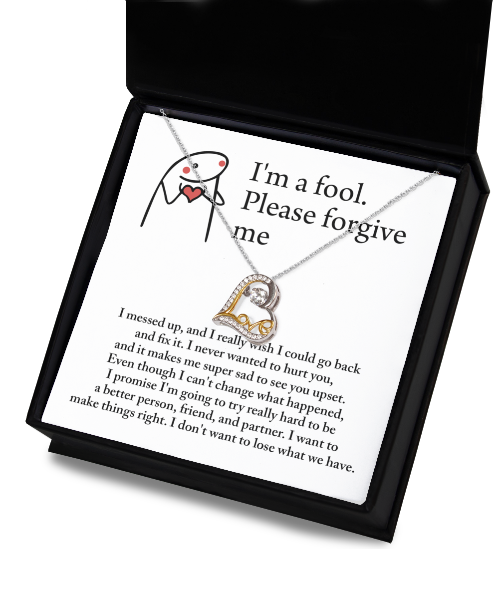 A Sorry-Make Things Right - Love Dancing Necklace with a heart pendant in 14k gold rests on a note with an apology message on it.