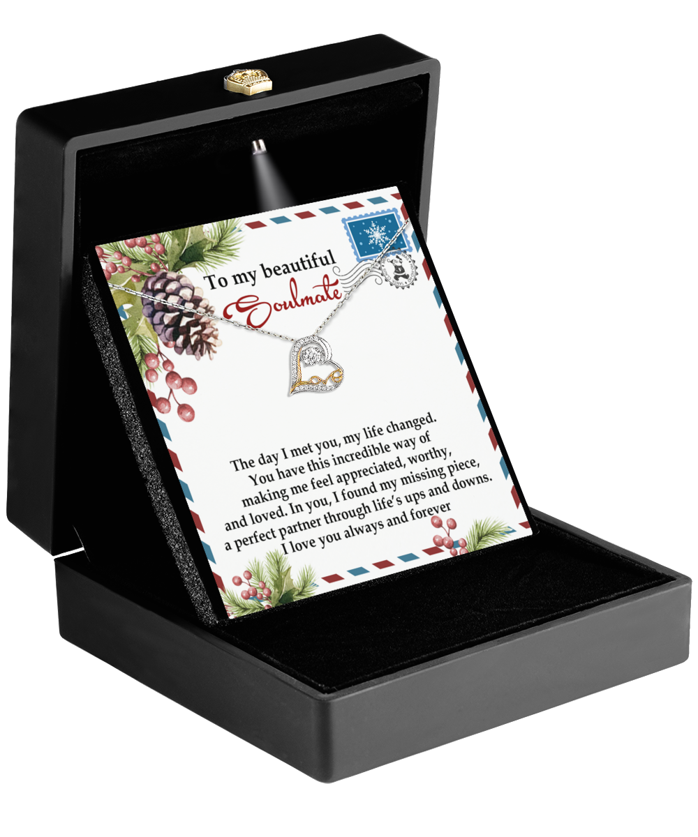 A black jewelry box with an open lid reveals the Soulmate-Perfect Partner - Love Dancing Necklace and a note that reads, "To my beautiful soulmate." The note, adorned with floral and pine cone designs, complements the allure of this rhodium-plated necklace.