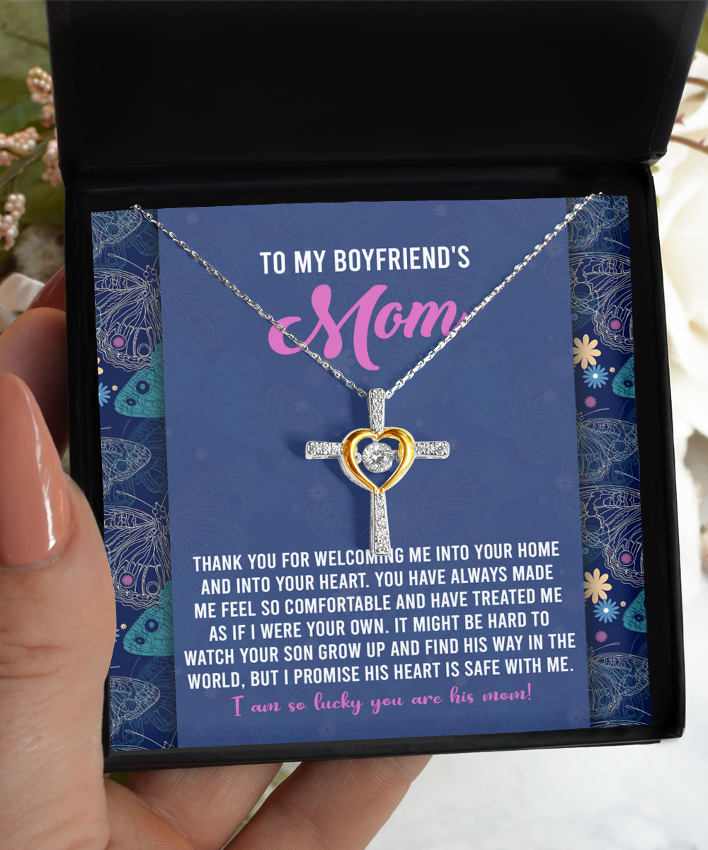 A hand holding an open gift box with a To Boyfriend's Mom, Safe With Me - Cross Dancing Necklace from Gearbubble, alongside a message to a boyfriend's mother expressing gratitude and affection.