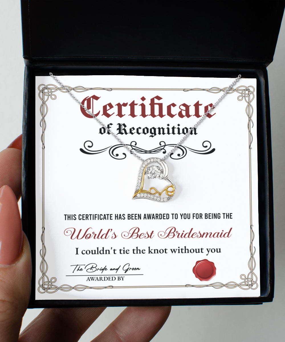 A certificate of recognition for the "World's Best Bridesmaid" displayed in a box with a stunning .925 sterling silver heart-shaped necklace, triple-plated in 14k gold. The certificate expresses heartfelt gratitude for her unwavering support during the wedding. Product Name: To Bridesmaid, Certificate Of Recognition - Love Dancing Necklace