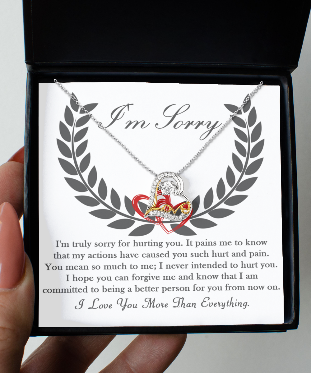 A "Sorry-From Now On - Love Dancing Necklace" is displayed inside an open black box. The Sterling Silver pendant necklace with a heart design comes with an apology message expressing deep regret and commitment to positive change.