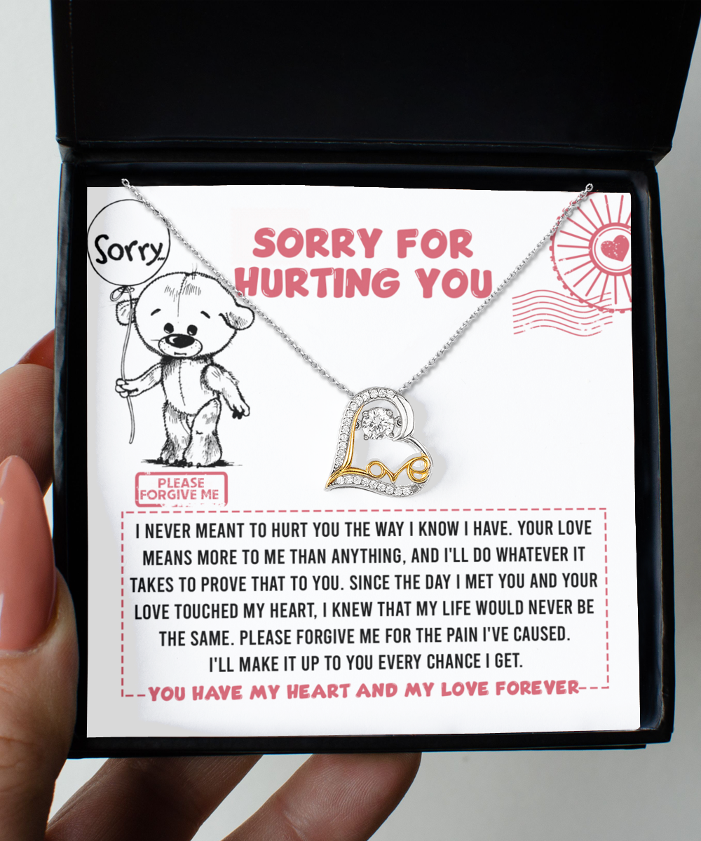 The "Sorry-Every Chance - Love Dancing Necklace" is a 14k gold necklace featuring a heart-shaped pendant, beautifully presented on a card with an illustrated bear holding a "Sorry" balloon and a heartfelt apology message that reads, "Sorry for hurting you.