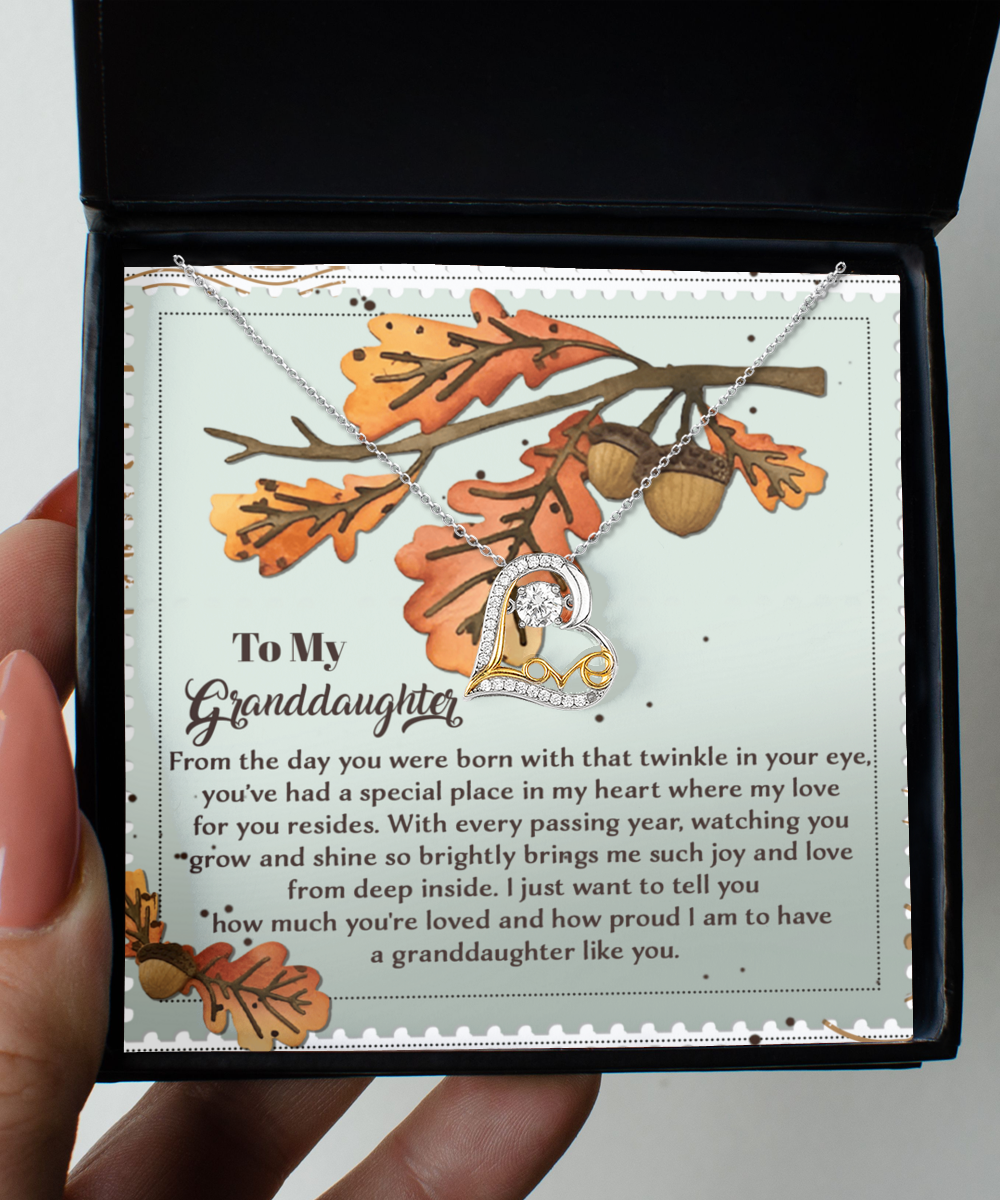 A heartfelt message for your granddaughter accompanies this decorative card, featuring the Granddaughter-From Deep Inside - Love Dancing Necklace, crafted with sterling silver and showcasing intertwined hearts to express love and pride.