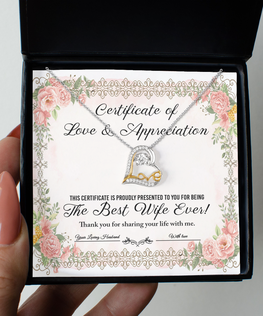 A "To Wife - Love & Appreciation" certificate adorned with floral borders and showcasing a heart-shaped, sterling silver Love Dancing Necklace, acknowledging the recipient as "The Best Wife Ever.