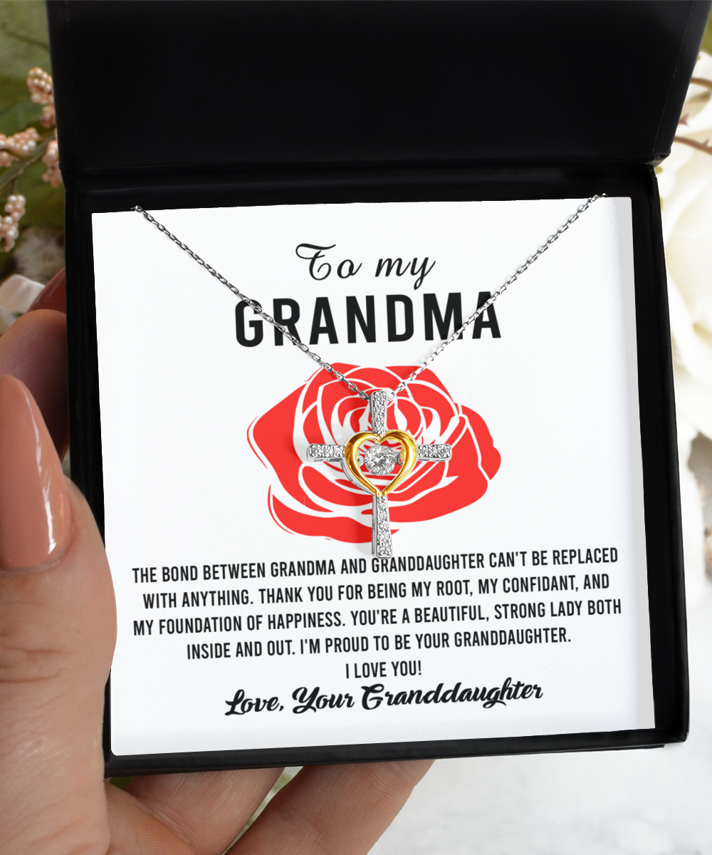 An open jewelry box with a 14k gold plated, Gearbubble "To Grandma, Strong Lady - Cross Dancing Necklace" and a heartfelt message to a grandmother from a granddaughter.