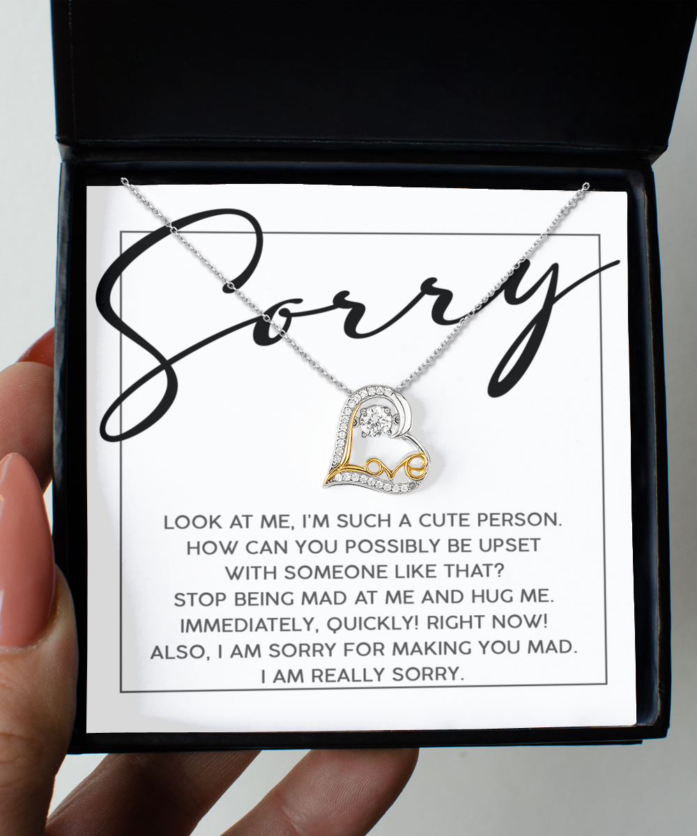 Gift box featuring the "Sorry-Someone Like That - Love Dancing Necklace," a 14k gold heart-shaped necklace, with an apology note: "Sorry. Look at me, I'm such a cute person...