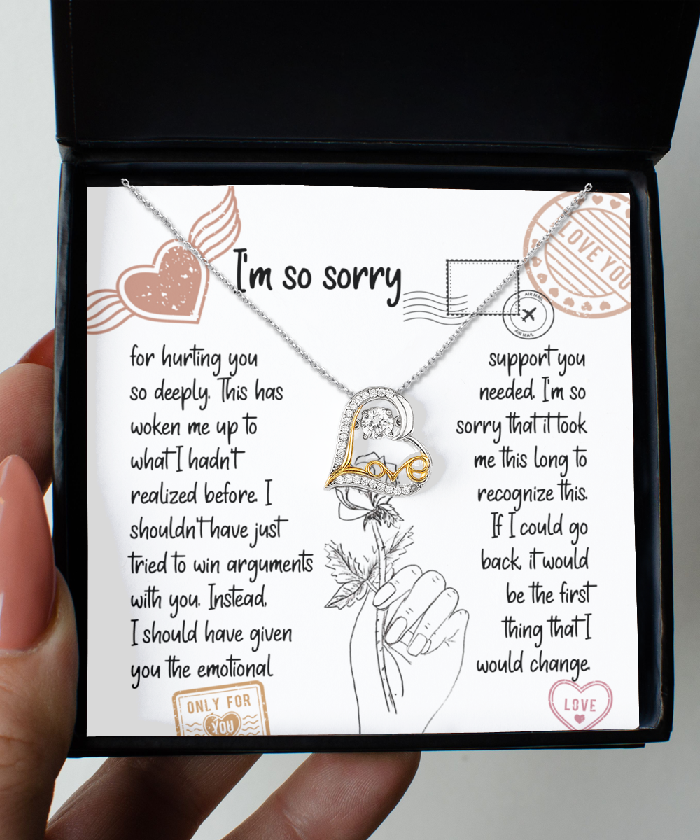 A "Sorry-Emotional Support- Love Dancing Necklace" with a heart pendant in .925 Sterling Silver is placed on an apology card inside a box. The card contains a heartfelt apology note with various decorative stamps and illustrations.