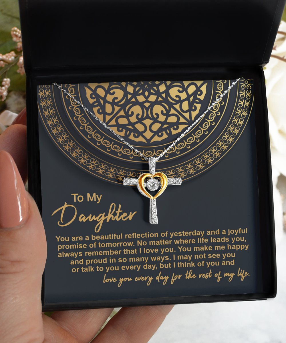 The "To Daughter-Beautiful Reflection - Cross Dancing Necklace" features a heart pendant in .925 Sterling Silver, elegantly presented in a black and gold gift box. Inside the box is a heartfelt message to a daughter, expressing pride, love, and happiness for her.