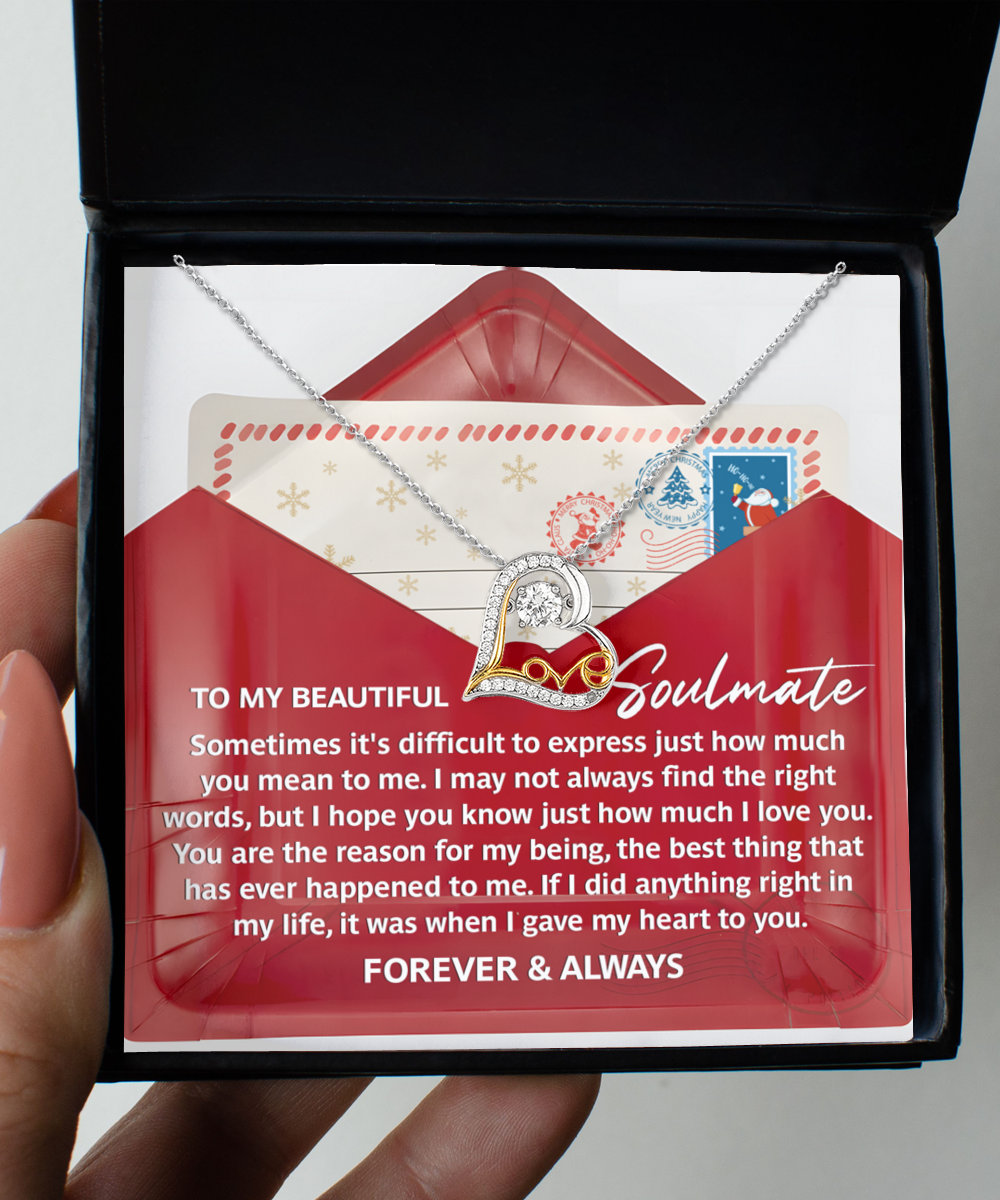 A hand holds an open jewelry box displaying a Soulmate-Right Words - Love Dancing Necklace in 14k gold, accompanied by a heartfelt message on a card inside, addressed to "My Beautiful Soulmate.