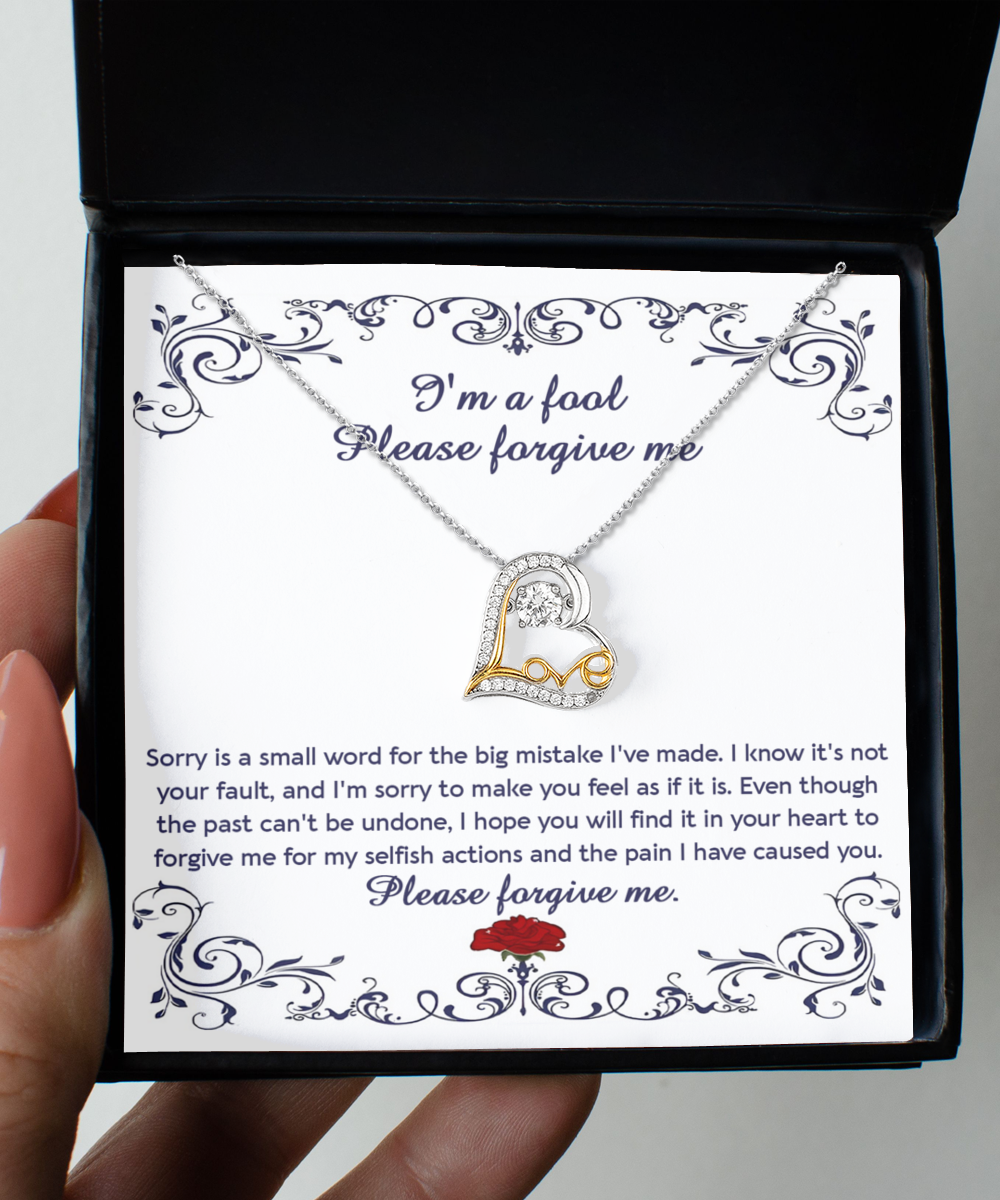 The "Sorry-I'm A Fool - Love Dancing Necklace" features a sterling silver chain with a heart-shaped pendant, elegantly presented in a box that includes an apology letter reading, "I'm a fool. Please forgive me," accompanied by an apologetic message and a rose illustration.