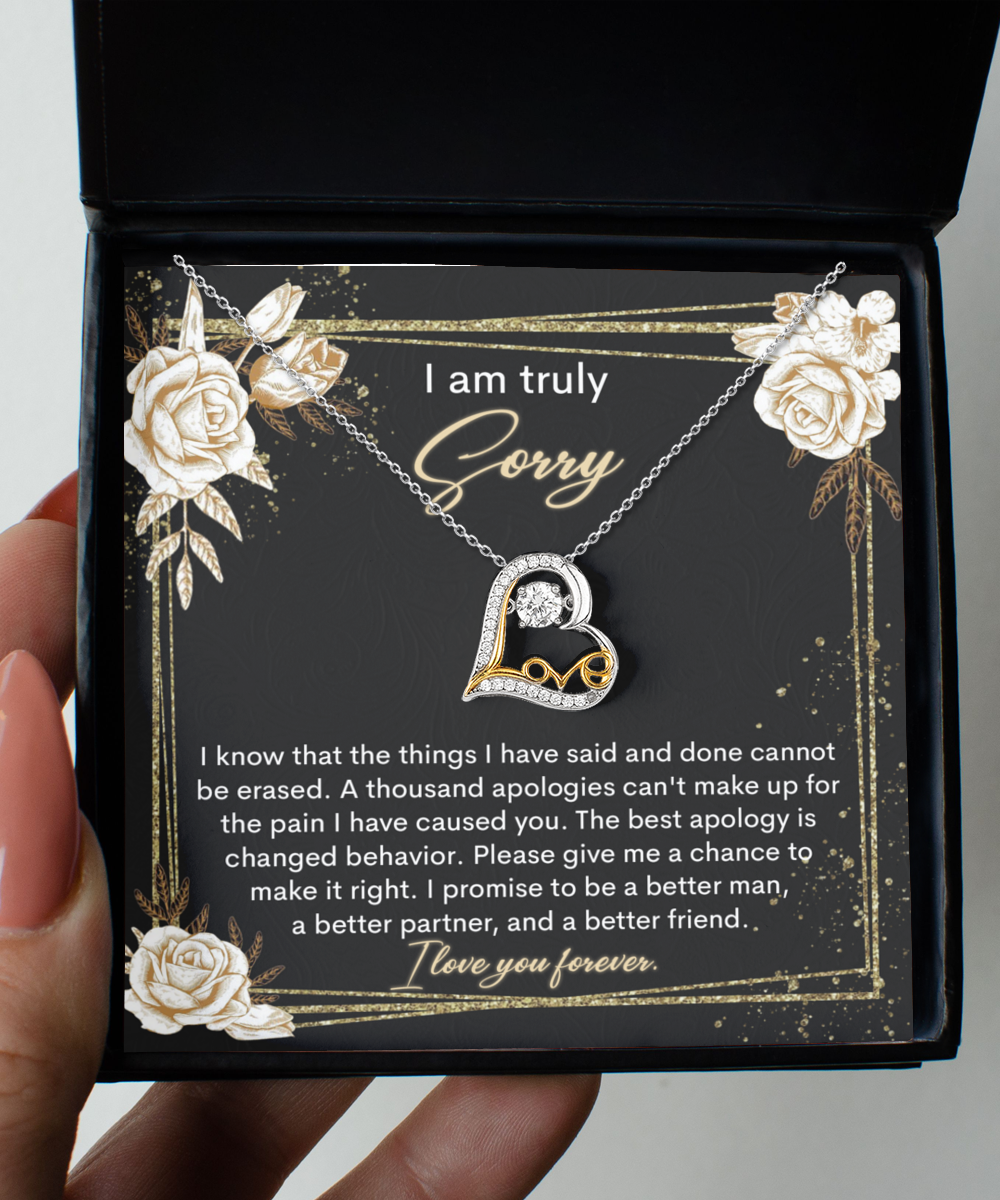 A "Sorry-Cannot Be Erased - Love Dancing Necklace" comes in a box with an apology note that reads, "I am truly sorry. I promise to be a better man, a better partner, and a better friend. I love you forever.